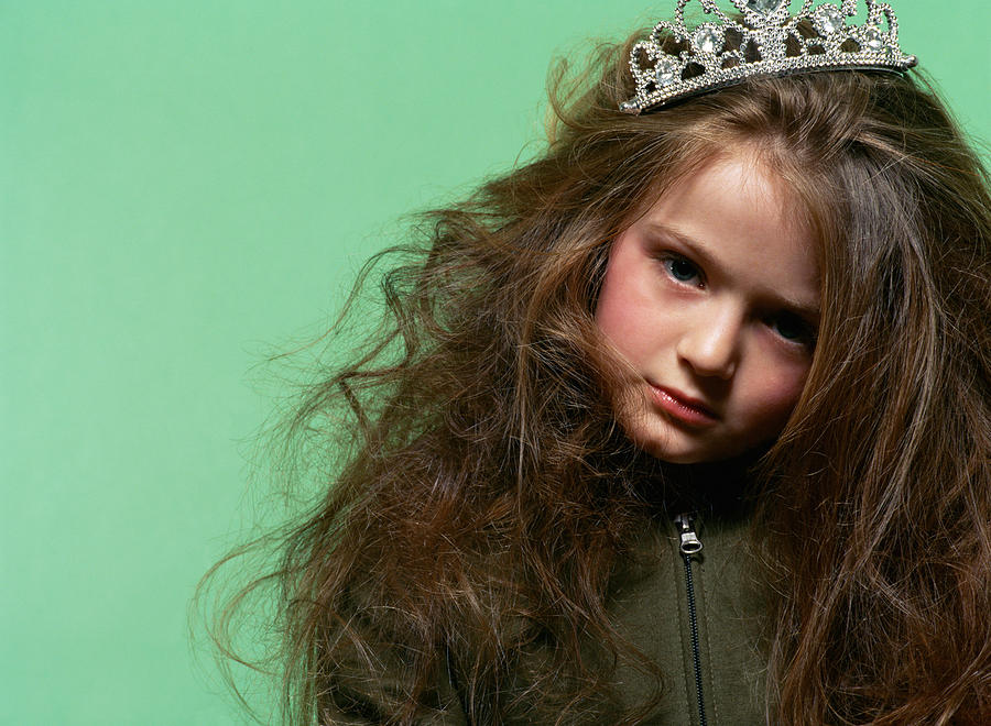 Sulky girl wearing a tiara Photograph by Image Source