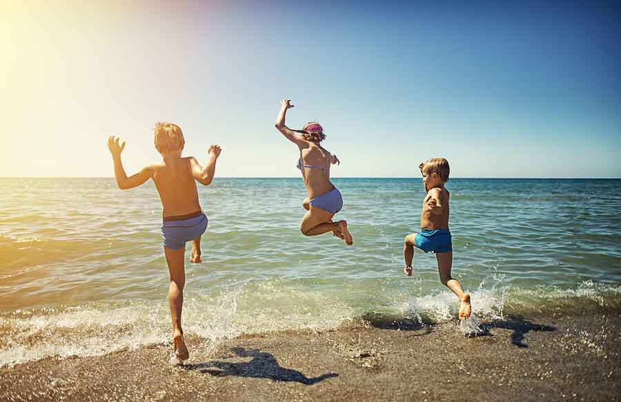 Summer vacations in Italy - kids jumping into the sea Photograph by Imgorthand