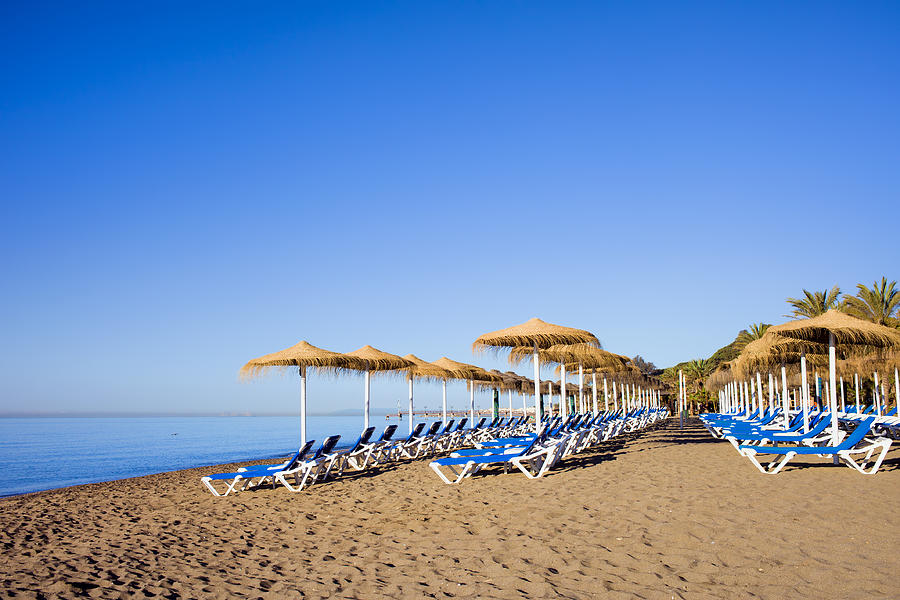 Sun Loungers on a Beach in Marbella Photograph by Artur Bogacki