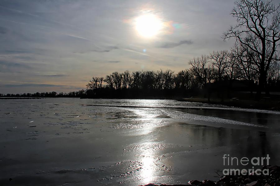 Sun reflecting on the frozen lake Photograph by Yumi Johnson