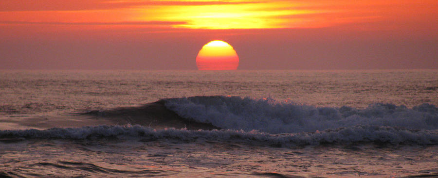 Sunset Photograph - Sun setting over the ocean by Meagan Johnson