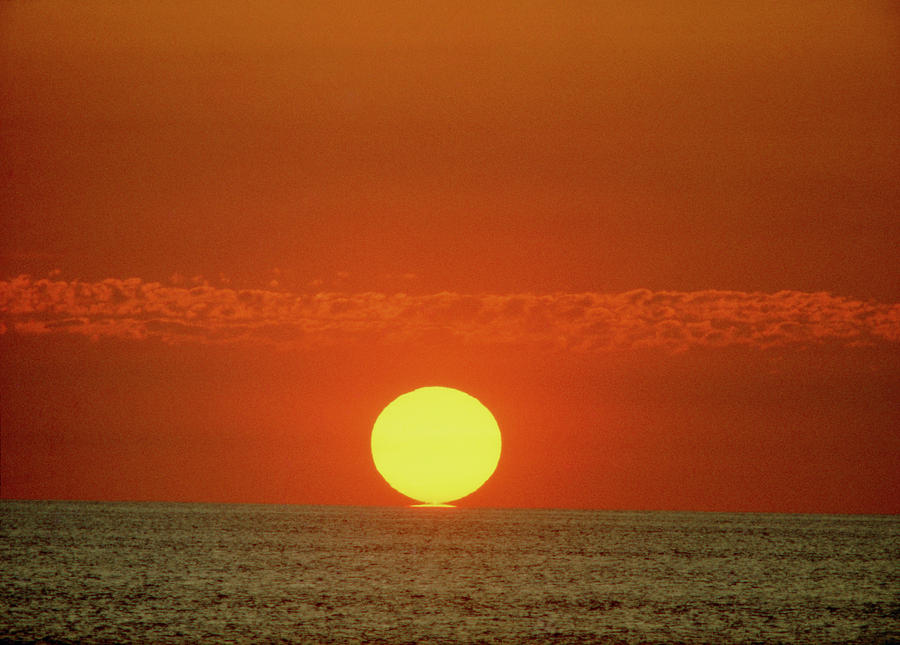 Sun Setting Over The Ocean Photograph by Ron Reid/science Photo Library.