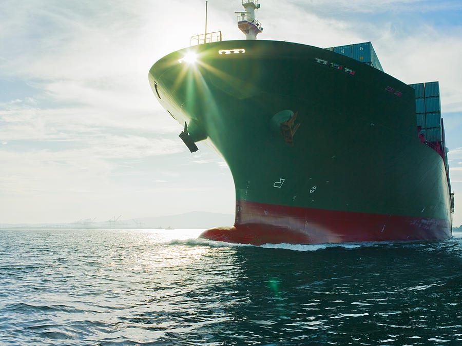 Sun shining through bow of cargo ship Photograph by Stewart Sutton