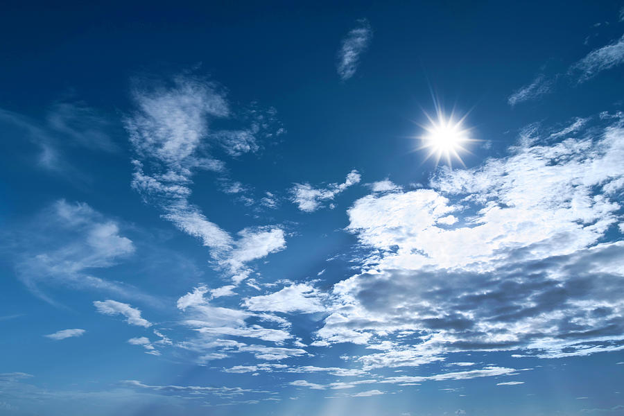 Sun Shinning On A Deep Blue Cloudy Sky Photograph by Apomares
