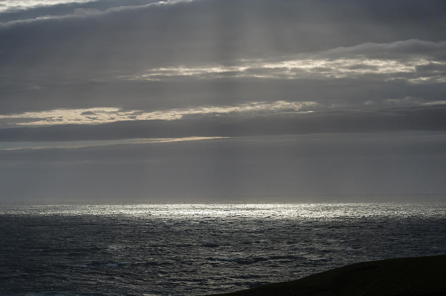 Sunlight at sea past Stoer Lighthouse Photograph by Gary Eason