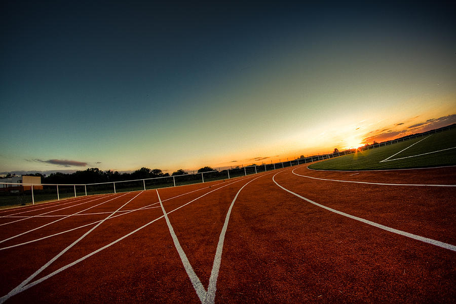 Sunrise on athletics track Photograph by Onnamusha