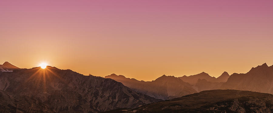 Sunrise over a mountain range Photograph by Buena Vista Images