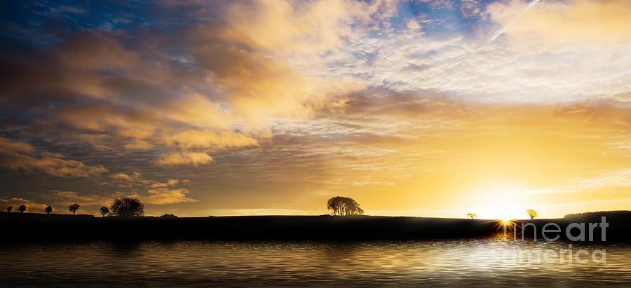 Sunrise over silouette landscape Photograph by Simon Bratt