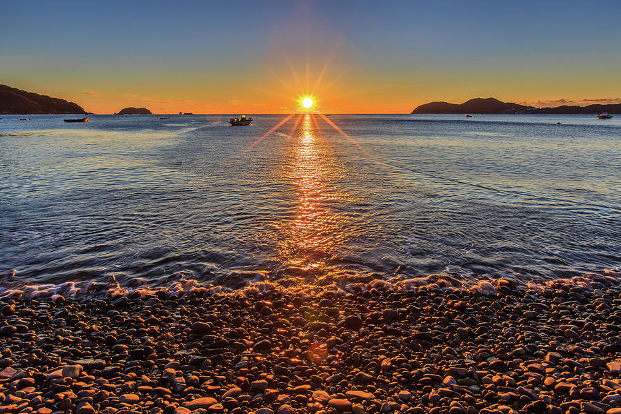 Sunrise Over The Pebble Beach Photograph by Sungjin Kim