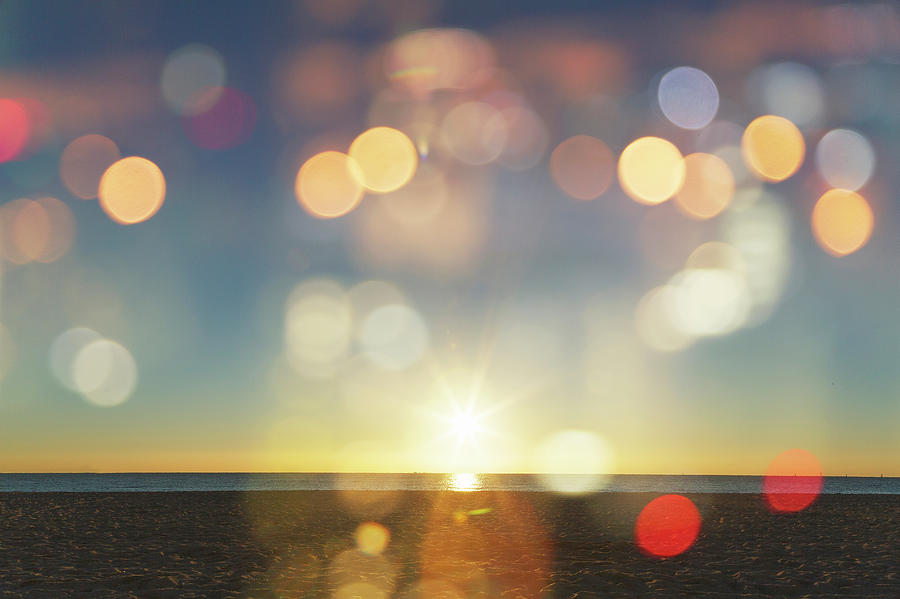 Sunrise With Lens Flares Over A Beach Photograph by Buena Vista Images