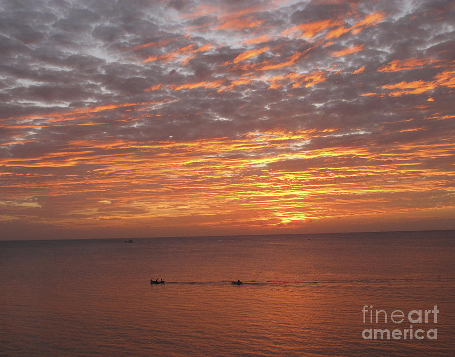Sunset and boats on ocean Photograph by Paula Joy Welter