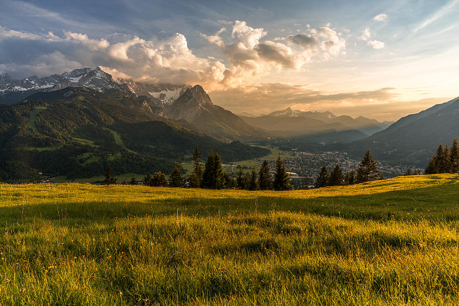 Sunset at a mountain pasture over Garmisch-Partenkirchen Photograph by Cyril Gosselin
