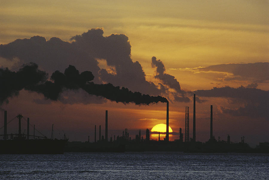 Sunset Behind Oil Refinery Photograph by Alain Evrard