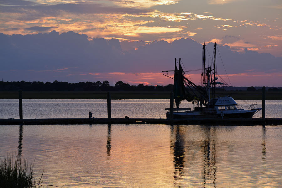 Sunset on Jekyll Island with Boat Reflection 02 Photograph by Bruce Gourley