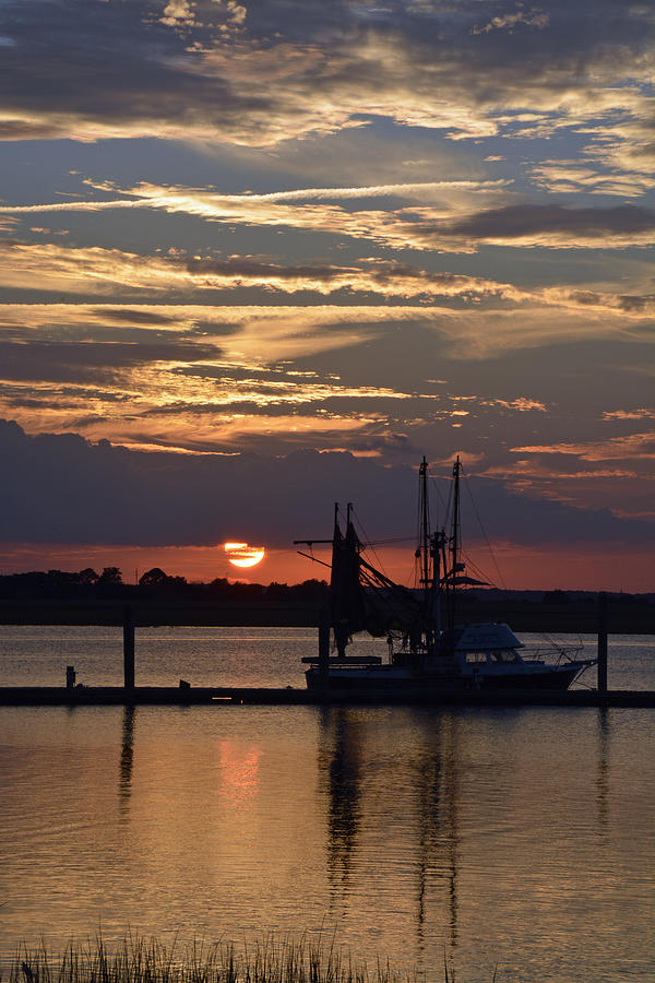 Sunset on Jekyll Island with Boat Reflection Photograph by Bruce Gourley
