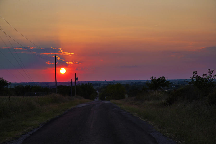 Sunset on the road heading west Photograph by Toni Hopper