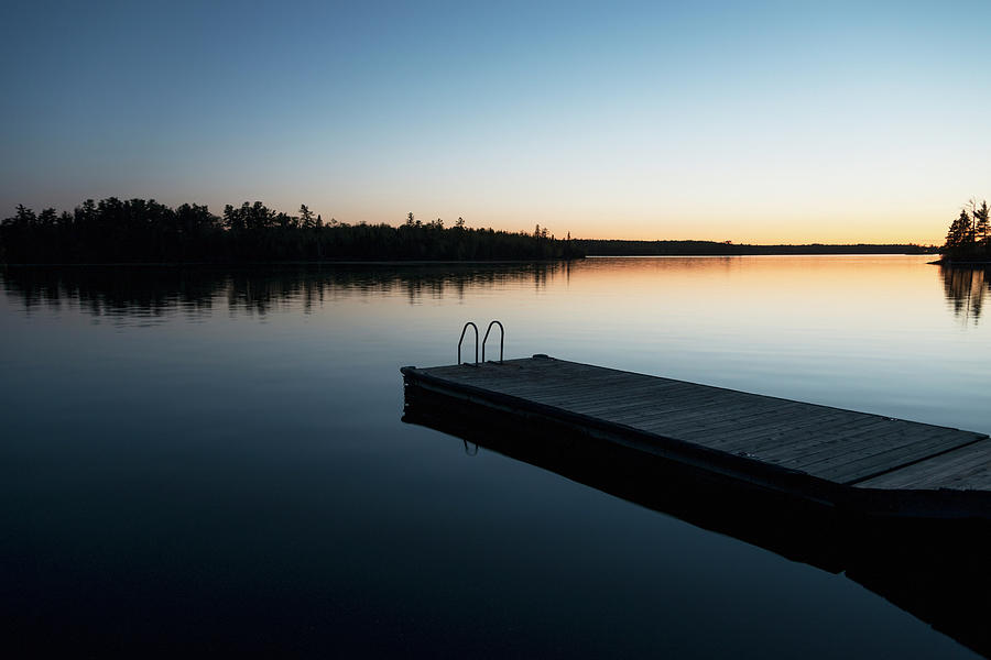Sunset Over A Lake With A Wooden Dock Photograph by Keith Levit / Design Pics