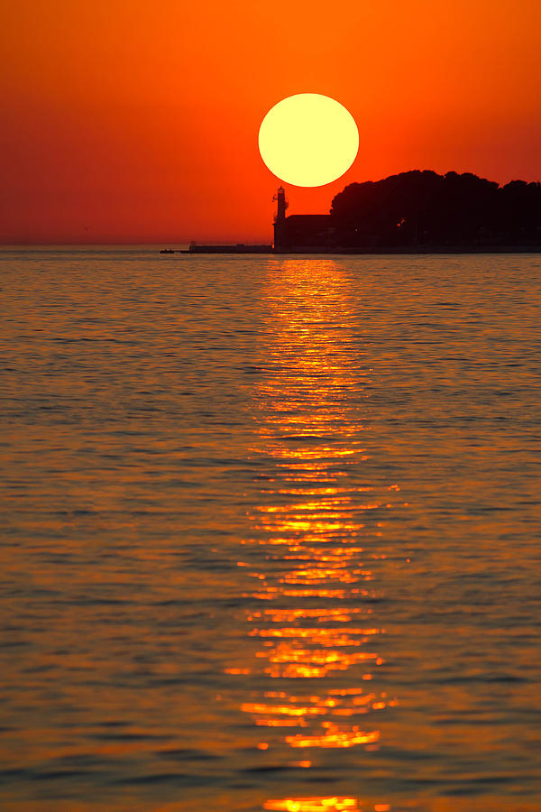 Sunset over lighthouse in Zadar Photograph by Brch Photography