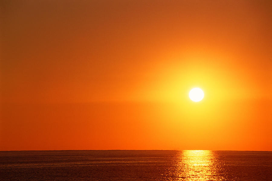 Sunset over ocean Photograph by Thinkstock Images