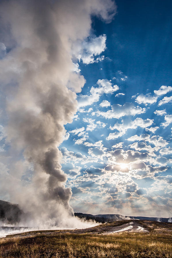 Sunset over Old Faithful - Vertical Photograph by Andres Leon