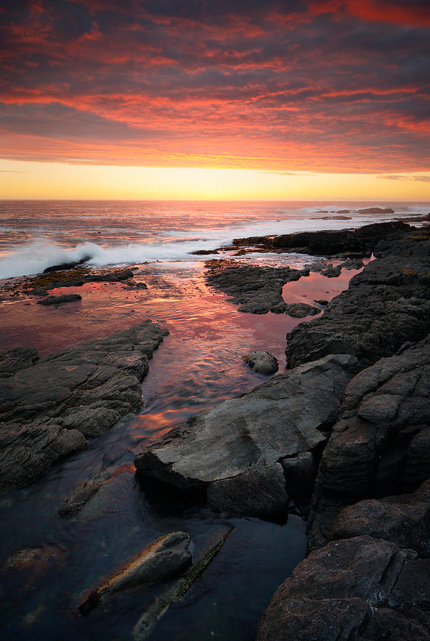 Ocean Photograph - Sunset over rocky coastline by Johan Swanepoel
