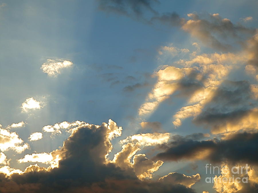Sunset Rays through the clouds. Photograph by Robert Birkenes