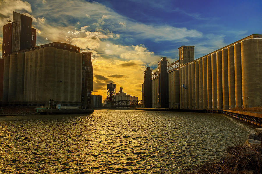 Sunsets on a river through an Industrial Canyon Photograph by Chris Bordeleau