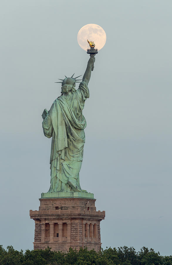 Super Moon Rises Over The Statue Of Liberty Photograph by Susan Candelario