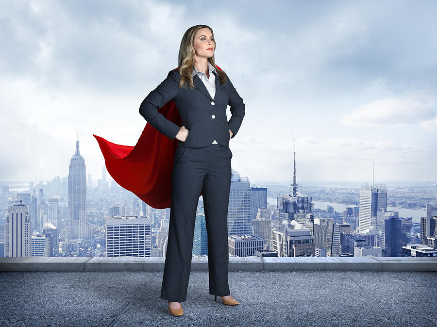 Superhero Businesswoman With Cityscape In The Background Photograph by Dny59