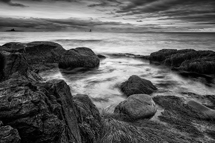 Surf Among The Boulders With Whaleback Light Photograph by Jeff Sinon