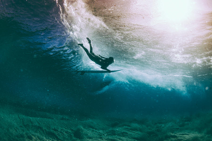 Surfer duck diving under a wave, Hawaii, America, USA Photograph by Mattpaul
