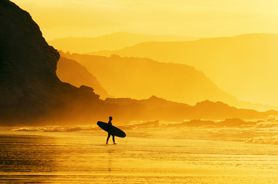 Surfer Entering Water At Misty Sunset Photograph by Mikel Martinez de Osaba