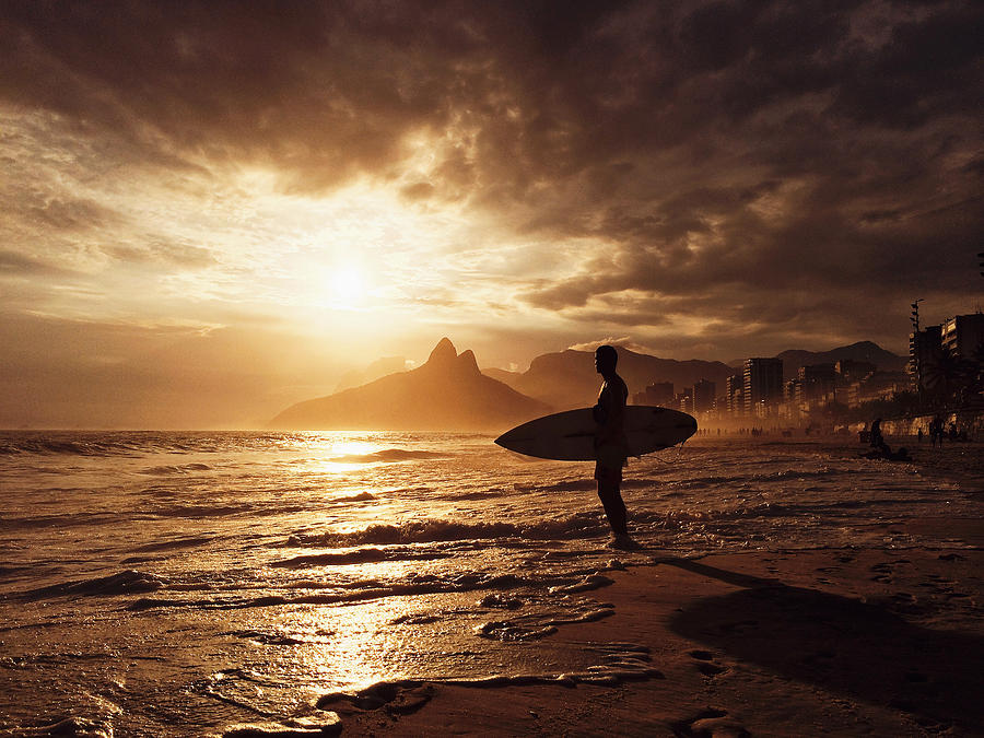 Surfer waiting for a wave during sunset at Ipanema Beach, Rio de Janeiro, Brazil Photograph by Alexander Spatari