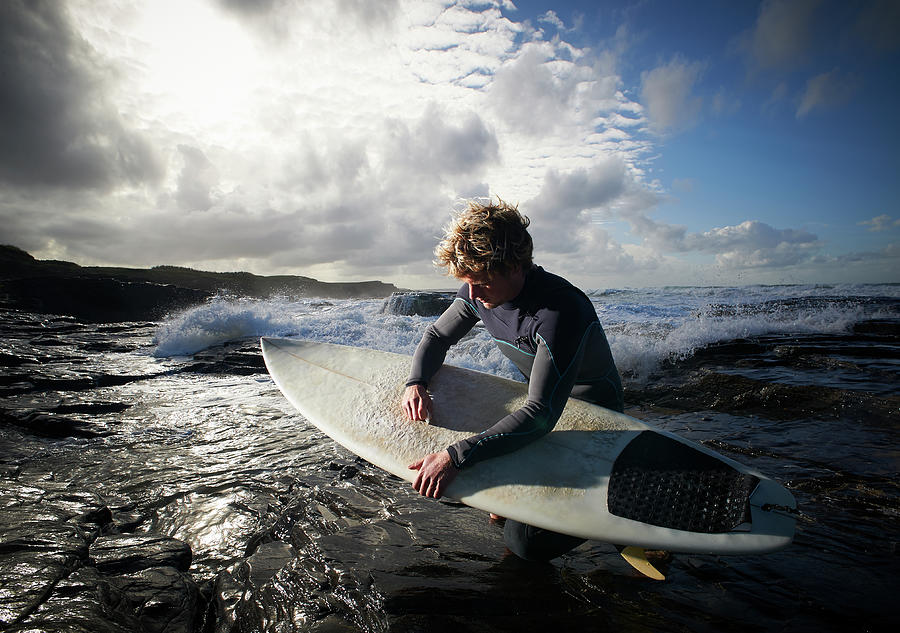 Surfer Waxing His Board Photograph by Dougal Waters