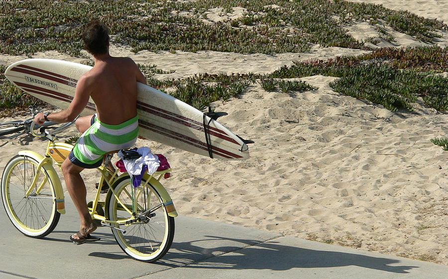 Surfer With Board On Bike Photograph by Jeff Lowe