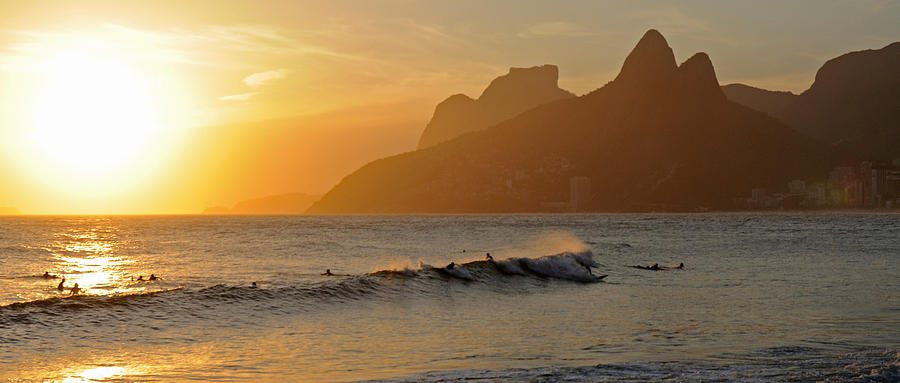 Sunset Photograph - Surfers At Sunset On Ipanema Beach, Rio by Panoramic Images