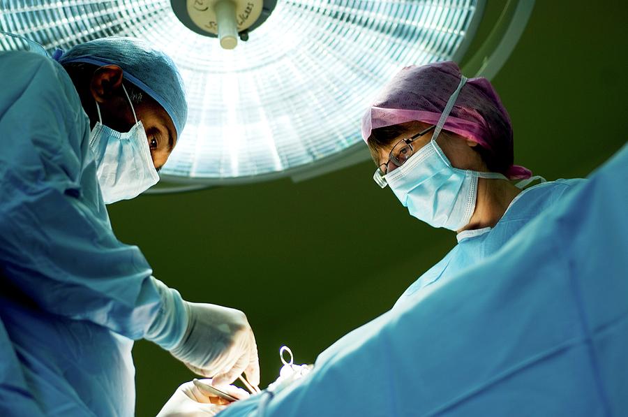 Surgeons Operating Photograph by Lth Nhs Trust/science Photo Library