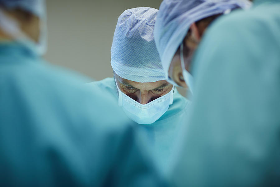 Surgeons working in operating room Photograph by Morsa Images