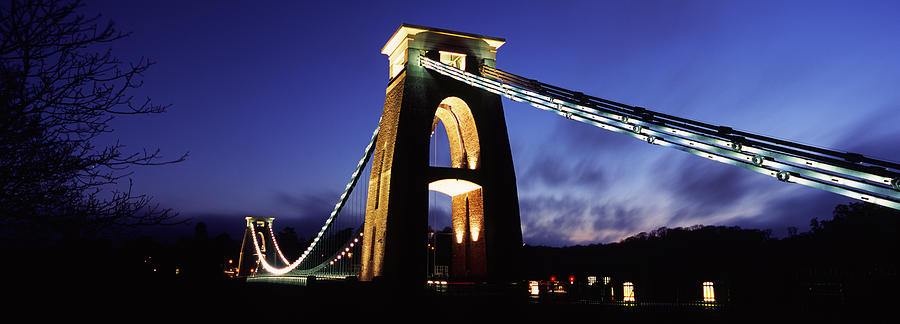 Architecture Photograph - Suspension Bridge Lit Up At Night by Panoramic Images
