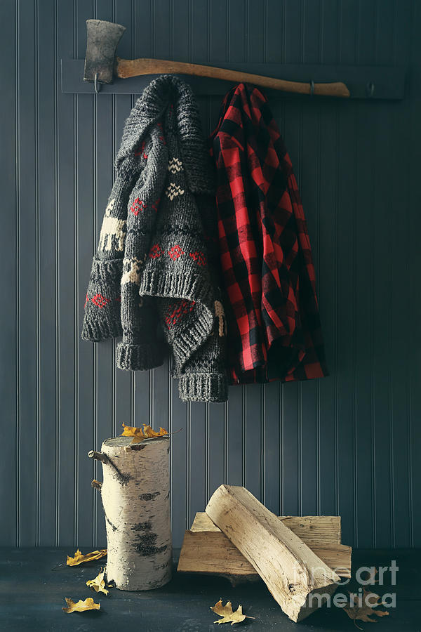 Sweater jacket hanging with firewood with axe Photograph by Sandra Cunningham