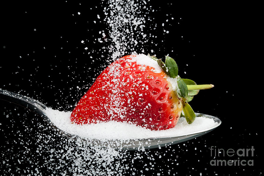 Sweet strawberry with sugar granules Photograph by Simon Bratt