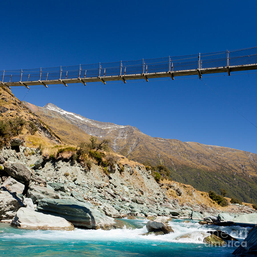 Architecture Photograph - Swing bridge high over glacial river New Zealand by Stephan Pietzko