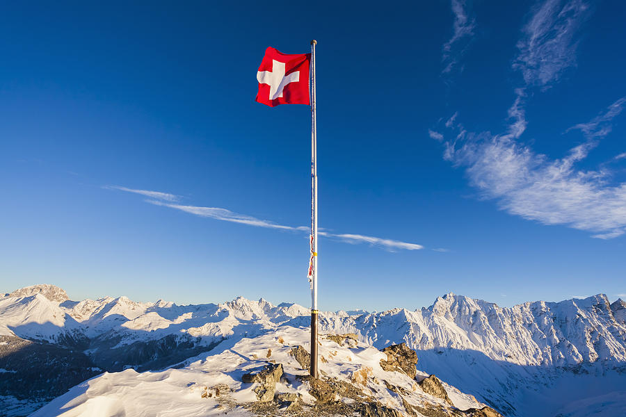 Switzerland, Graubuenden, Savognin, Mountaintop Piz Martegnas, swiss flag Photograph by Westend61