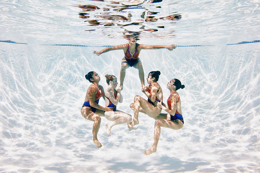 Synchronized swim team preparing to perform lift Photograph by Thomas Barwick