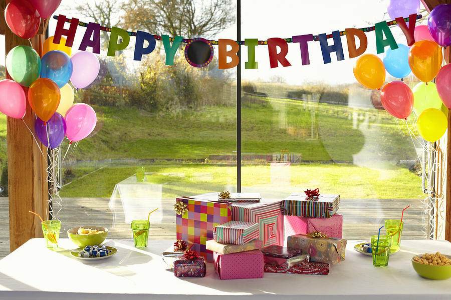 Table laid with birthday gifts and balloons Photograph by Tim Macpherson