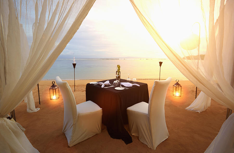 Table prepared for romantic dinner at beach Photograph by Colin Anderson Productions pty ltd