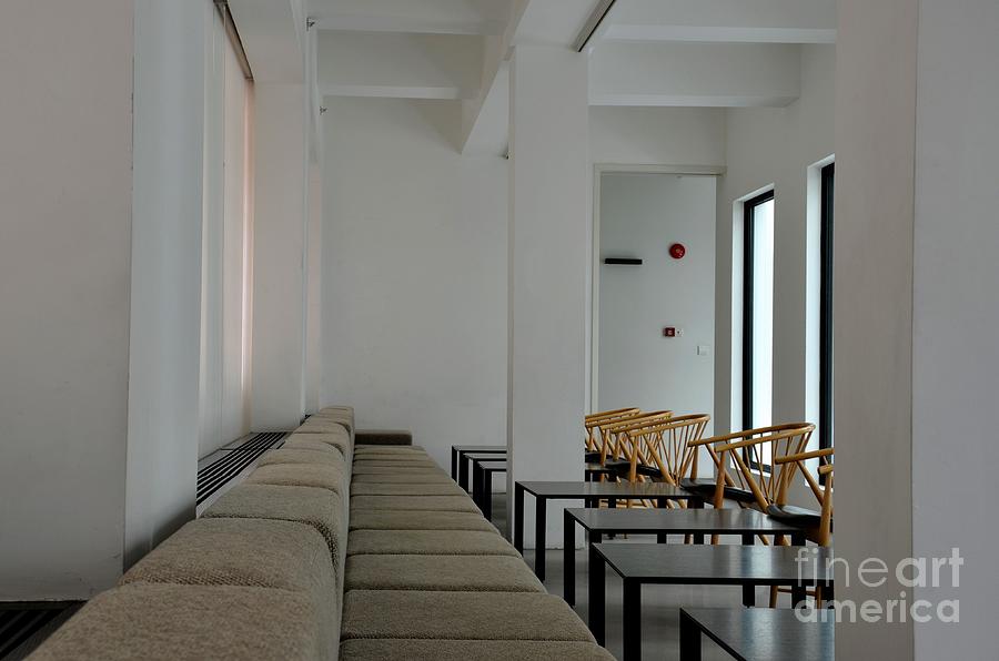 Tables sofa and cane chairs in modern minimalist restaurant setting Photograph by Imran Ahmed
