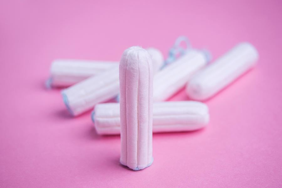 Tampons on pink background Photograph by Emilija Manevska