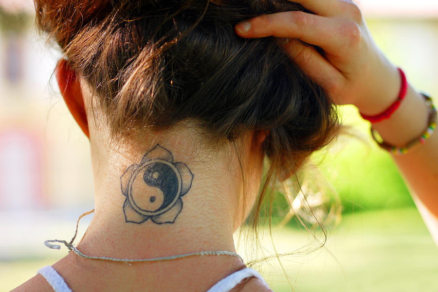 Tattoo on young womans nape Photograph by Rosmarie Wirz