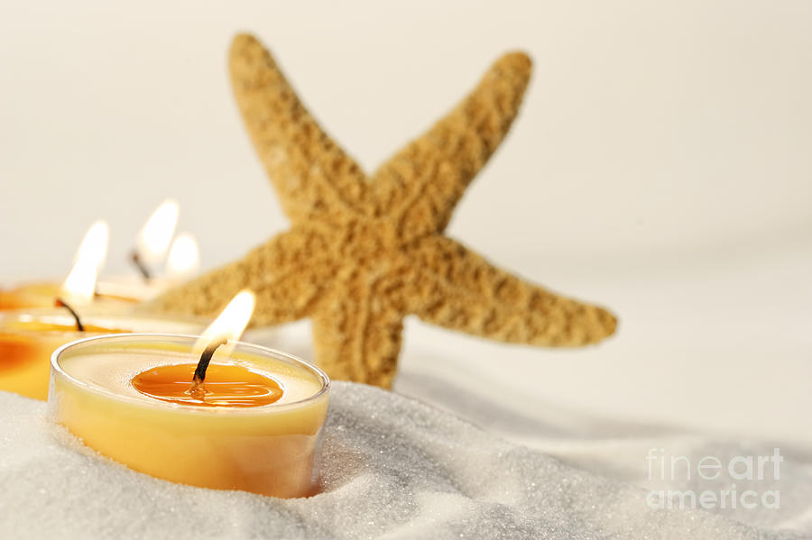 Tea light candles in sand with star fish Photograph by Sandra Cunningham